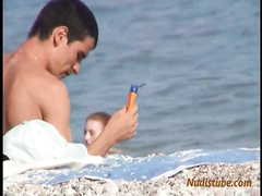 Redhead nudist teen comes out of the water