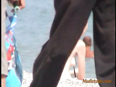 Redhead nudist teen comes out of the water