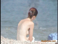 Redhead nudist teen comes out of the water