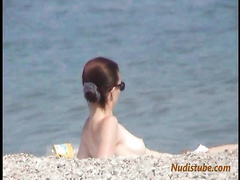 Redhead nudist teen comes out of the water
