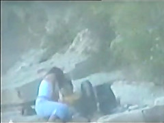 teen couple caught on the beach