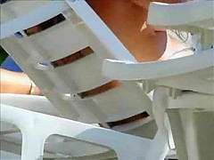 Hidden cam on beach topless brunette