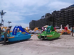 Two candid women topless on beach