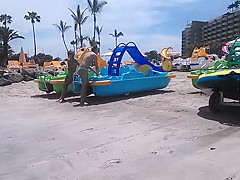 Two candid women topless on beach