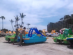 Two candid women topless on beach