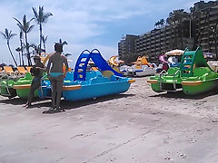 Two candid women topless on beach