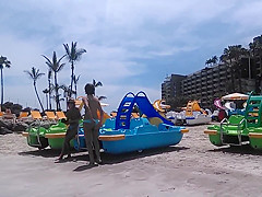 Two candid women topless on beach