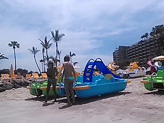 Two candid women topless on beach