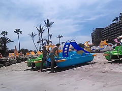 Two candid women topless on beach