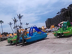 Two candid women topless on beach