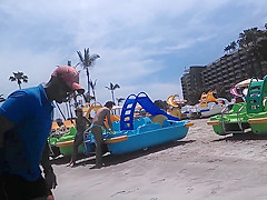 Two candid women topless on beach