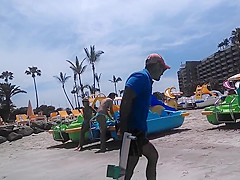 Two candid women topless on beach
