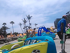 Two candid women topless on beach
