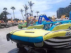 Two candid women topless on beach