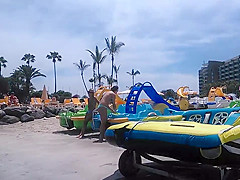 Two candid women topless on beach