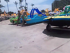 Two candid women topless on beach
