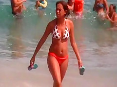 a brunette with a beautiful ass on the beach