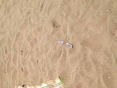 Black thong laying down on beach