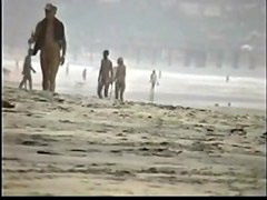 Couple play on the nude beach