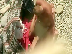 Spying horny couple on the beach