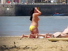 Chubby beach brunette topless