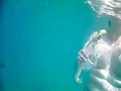Topless thick MILF under the water for voyeurs