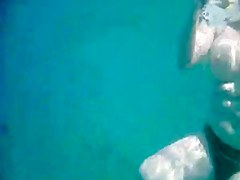 Topless thick MILF under the water for voyeurs