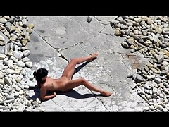 Slim tanned girl lying, legs spread got slippers on pussy