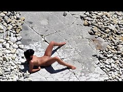 Slim tanned girl lying, legs spread got slippers on pussy