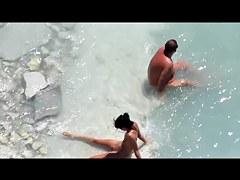 Slim tanned girl lying, legs spread got slippers on pussy