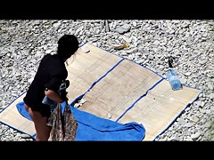 Slim tanned girl lying, legs spread got slippers on pussy