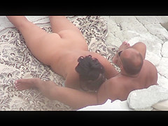 Mature woman does blowjob man and has sex on a public beach