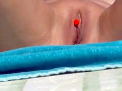 Pierced clit on the beach