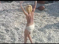 Voyeur on public beach. Funny dancing