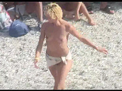 Voyeur on public beach. Funny dancing