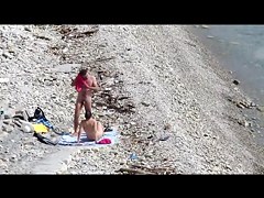 Couple fucked on a public beach while as people walked near