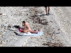 Couple fucked on a public beach while as people walked near
