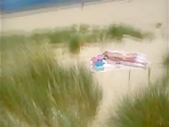 Mature beach voyeured topless (caught!)