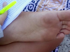 Candid soles at beach - teen studying