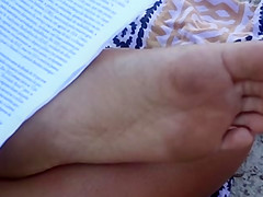 Candid soles at beach - teen studying