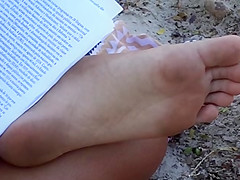 Candid soles at beach - teen studying
