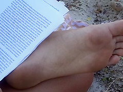 Candid soles at beach - teen studying