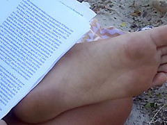Candid soles at beach - teen studying