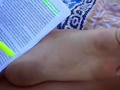 Candid soles at beach - teen studying