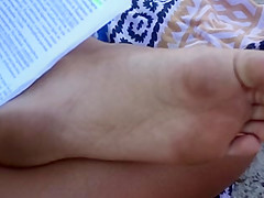 Candid soles at beach - teen studying