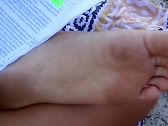 Candid soles at beach - teen studying