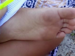 Candid soles at beach - teen studying