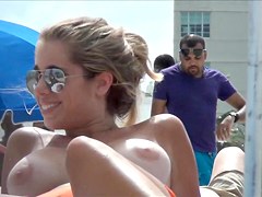 Topless beach girl with massive tits