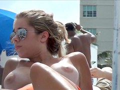 Topless beach girl with massive tits