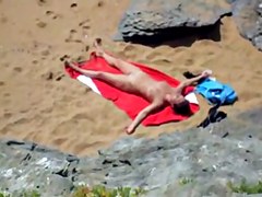 Nude girl on beach sunning.